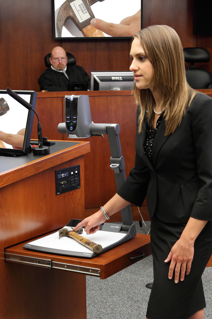 A law student using a WolfVision VZ-9plus³ to present evidence during a mock trial in the McGlothlin Courtroom.